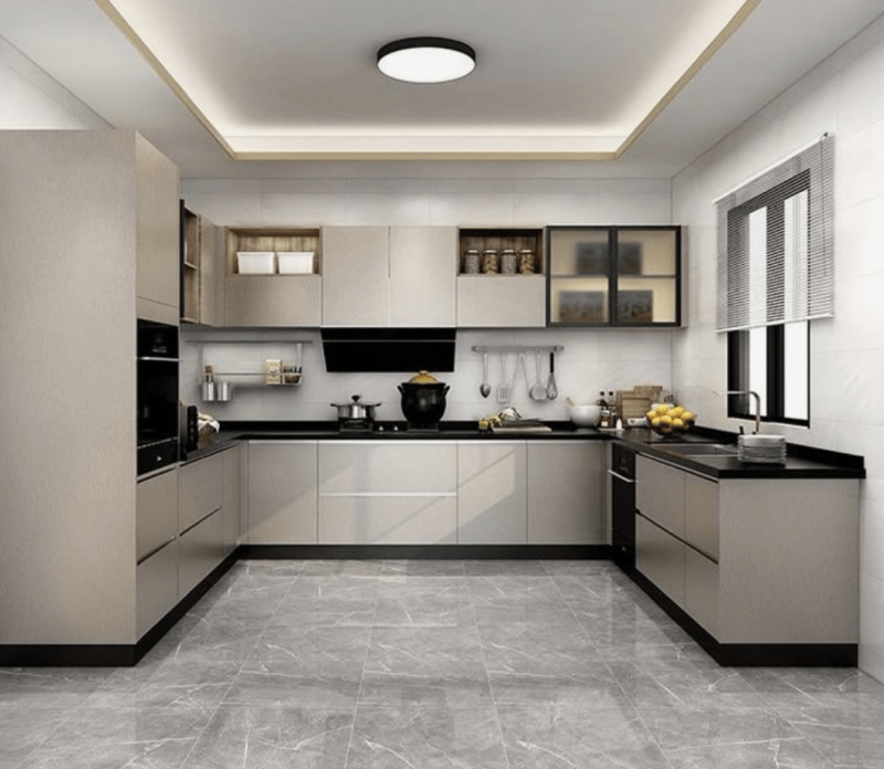 Modern U-shaped modular kitchen with light gray cabinets, black countertops, LED lighting, and marble flooring by Modular Kitchen DSI