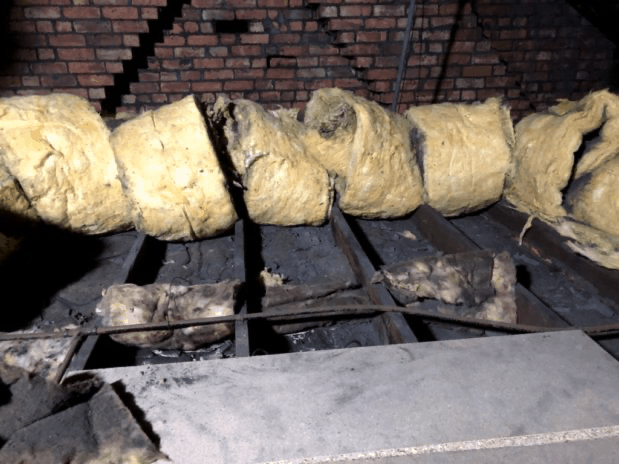 Insulation rolled back between joists