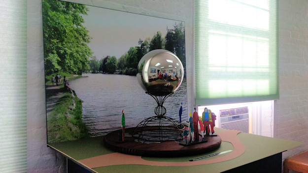 A mockup of a proposed 8ft stainless steel globe sculpture titled One World. The design was originally envisioned for the north side of the pedestrian bridge