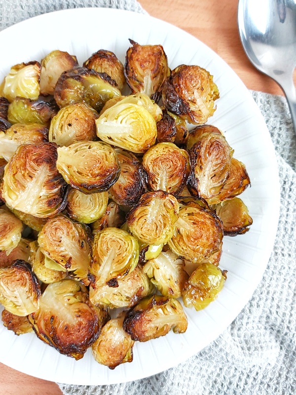 Crispy Roasted Brussels sprouts are not just incredibly easy to prepare, but also, one of the most popular holiday side dishes! Keto and low-carb friendly as well! #brusselssprouts #sidedish #keto #ketosidedish #holidaysrecipes #christmasrecipes #christmassidedish