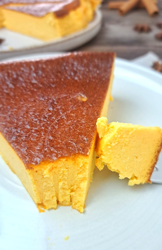 Sift the flour into the cheesecake and mix on low until no lumps are visible. Add the pumpkin, cinnamon, cloves, nutmeg, and vanilla and mix well. Pour the batter into the prepared pan and place on a large baking sheet pan. Place into the oven and bake for 45 minutes. The cheesecake should be dark and golden but still be able to wobble when nudged. Let the cake cool down completely at room temperature. This will take a few hours. The cake may sink a bit in the middle as it cools down. Cover with a cling wrap and store in the fridge for at least 6 hours before slicing.