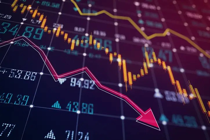 A person reviewing investment charts on a digital screen, illustrating how to protect your investments during market volatility