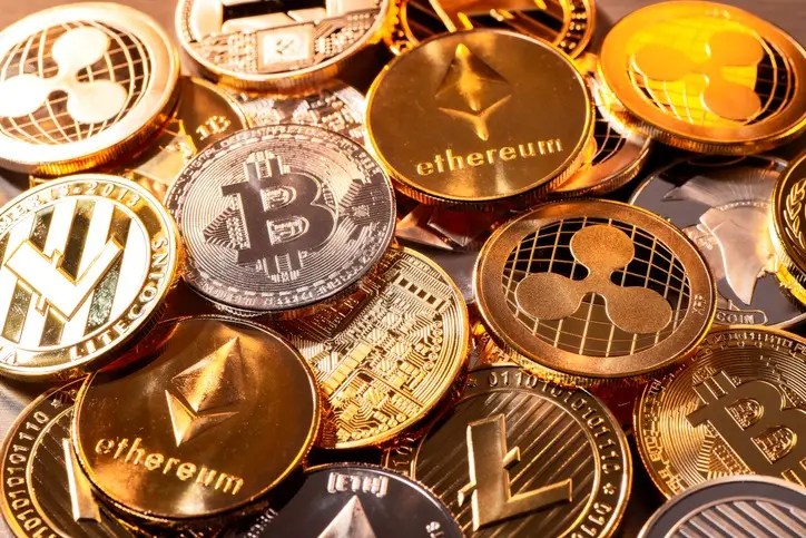Assorted cryptocurrency coins including Bitcoin, Ethereum, Ripple, and Litecoin representing cryptocurrency investing and volatile markets