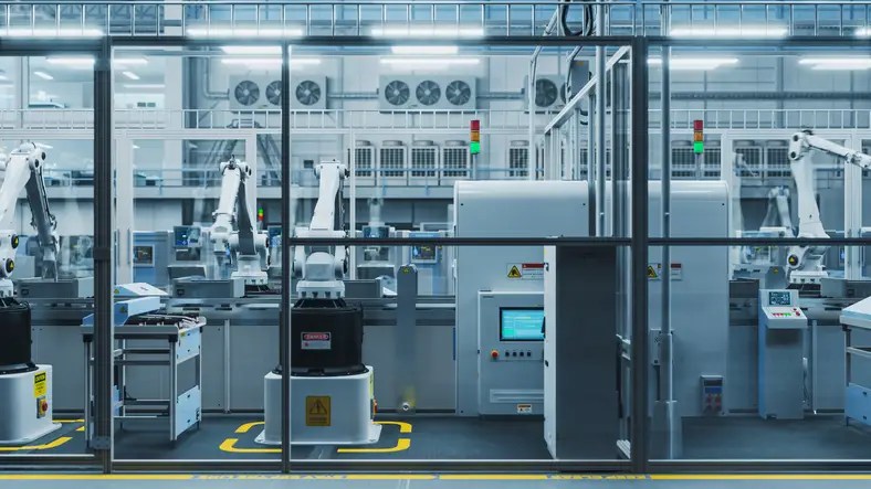 Automated robotic arms working in a modern factory, representing AI and automation transforming the future of manufacturing and jobs.