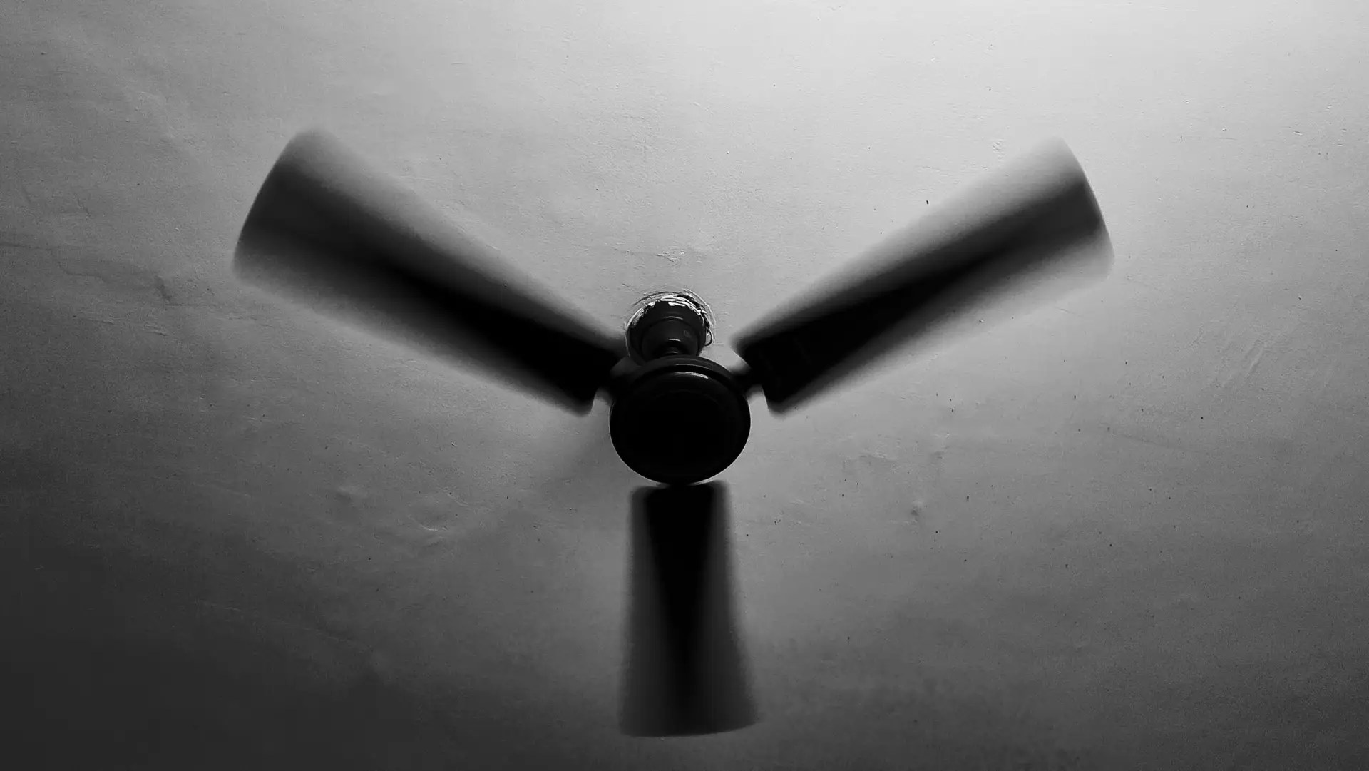 A black and white image of a ceiling fan