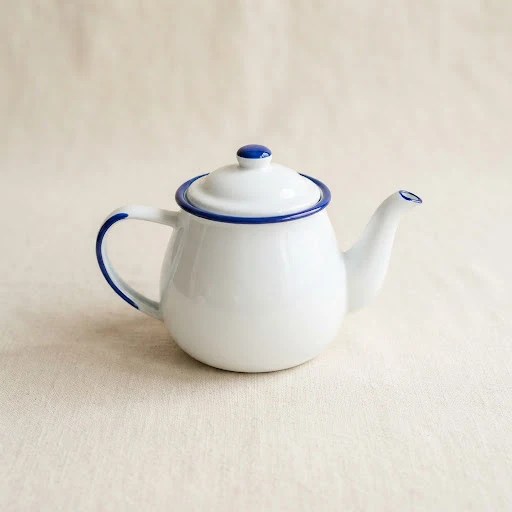 White enamel teapot with cobalt blue rim for tea, beverage and gifting collections