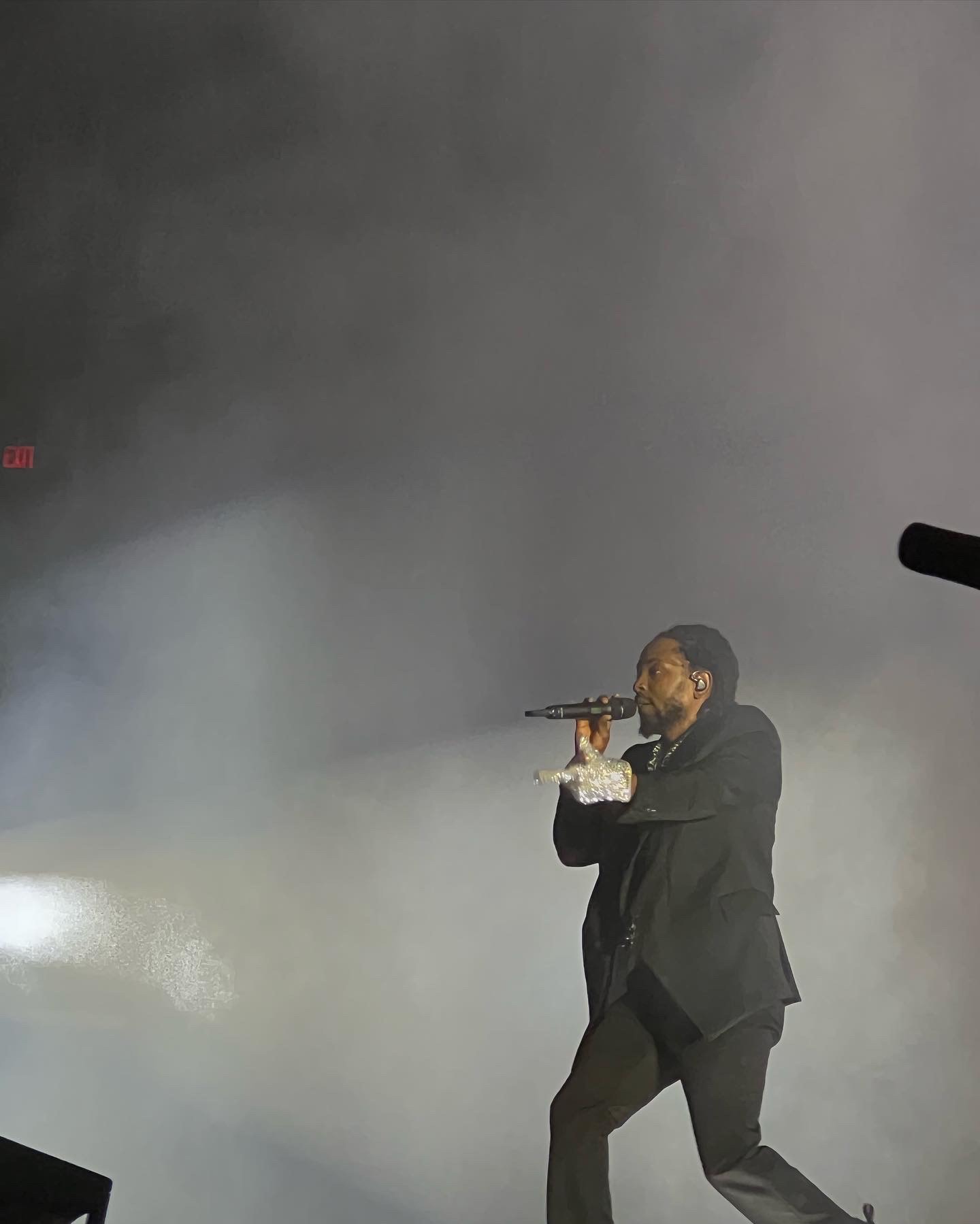 Kendrick Lamar raps into a microphone.