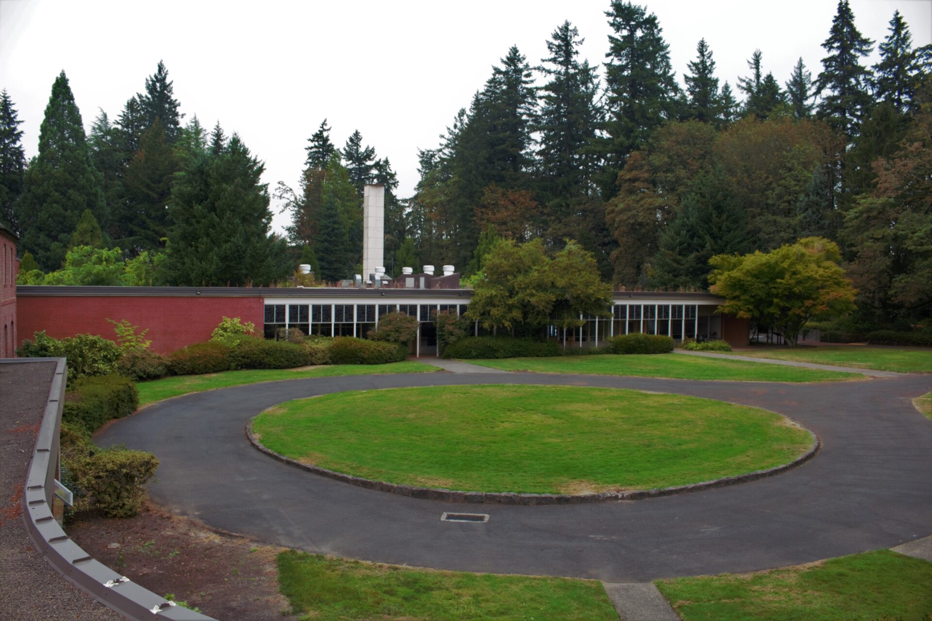A circular driveway around a green lawn on the graduate campus.