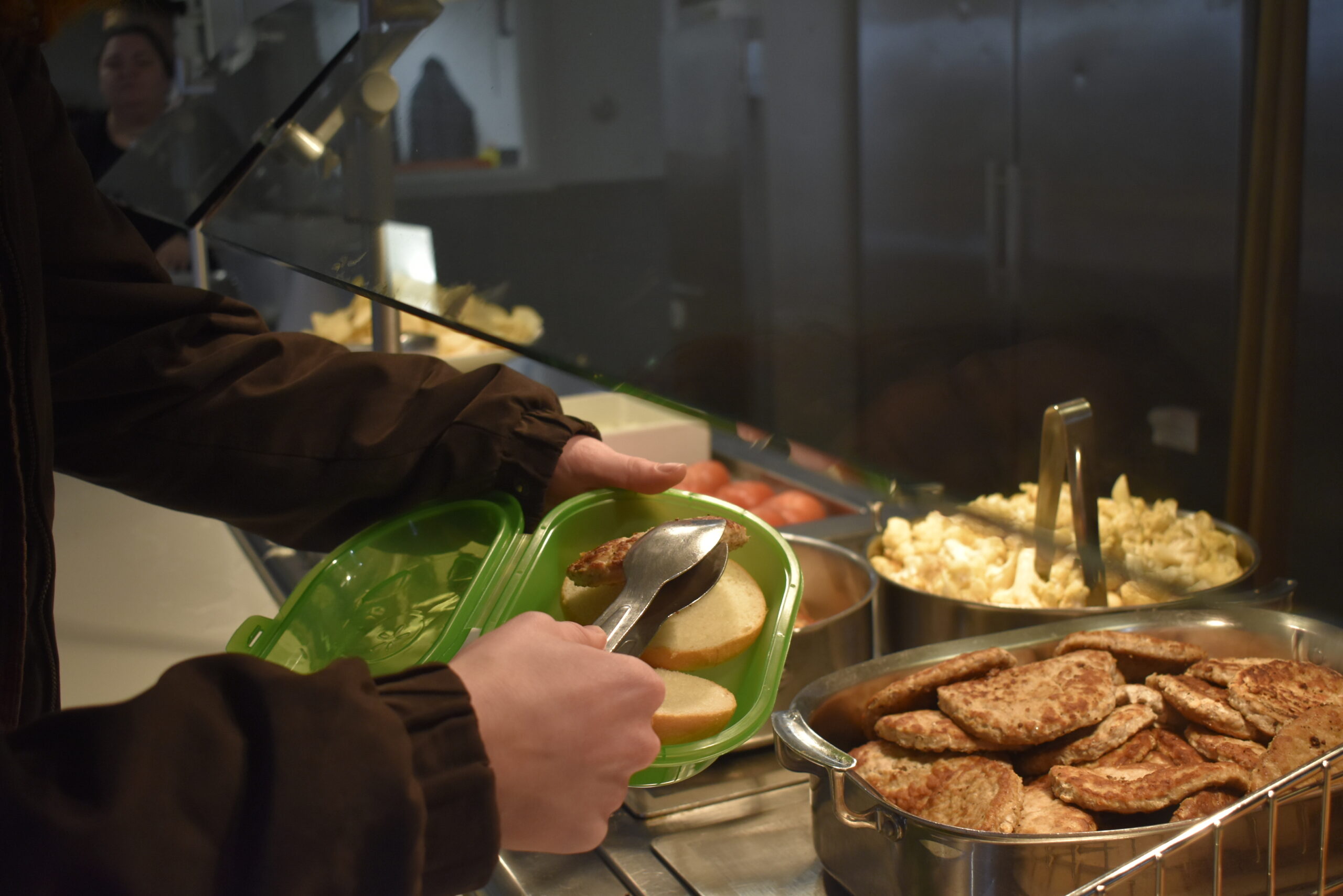Photo of student scooping food into eco-econtainer