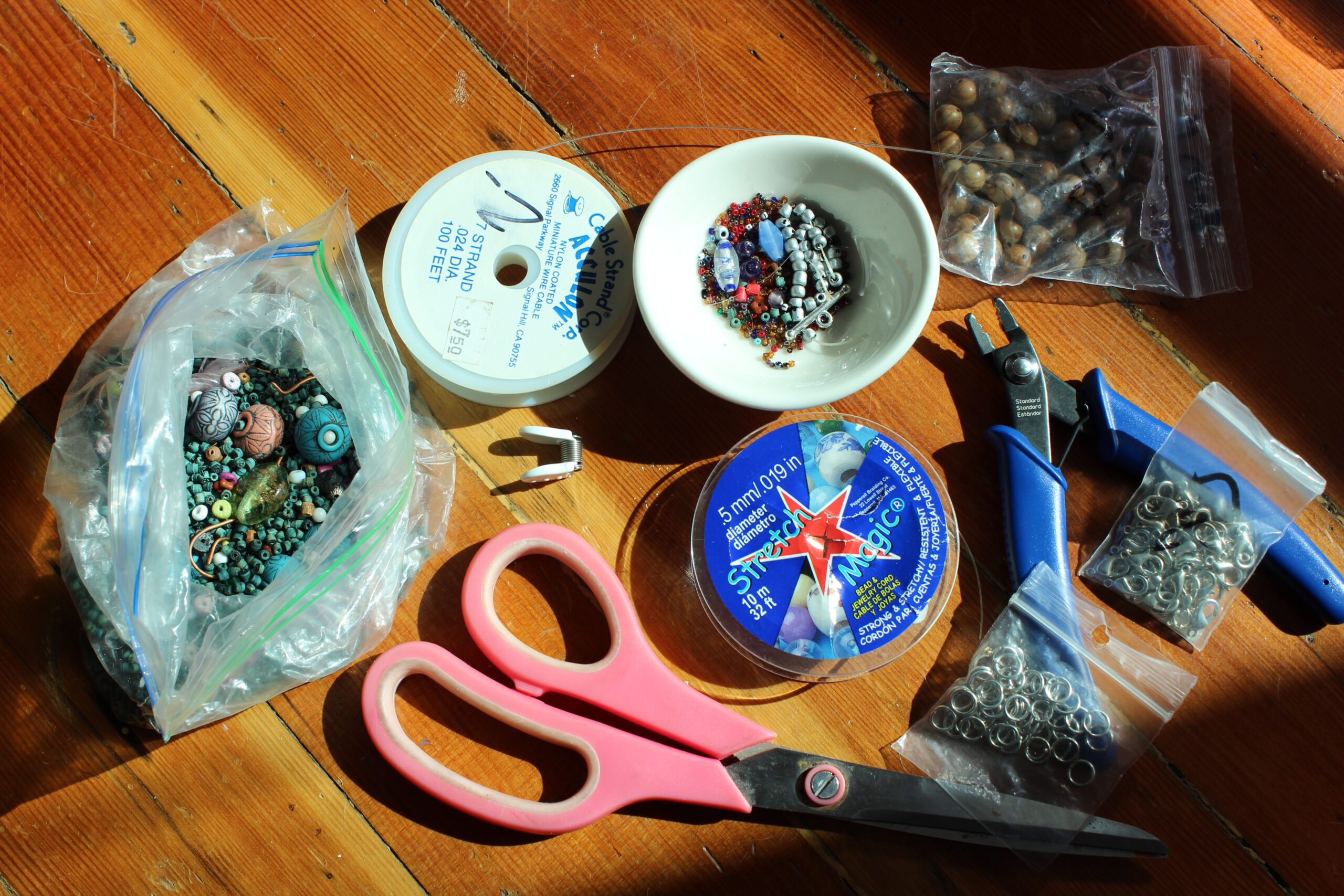 Photo of Tools essential for making jewelry, including scissors, wire, beads, and pliers
