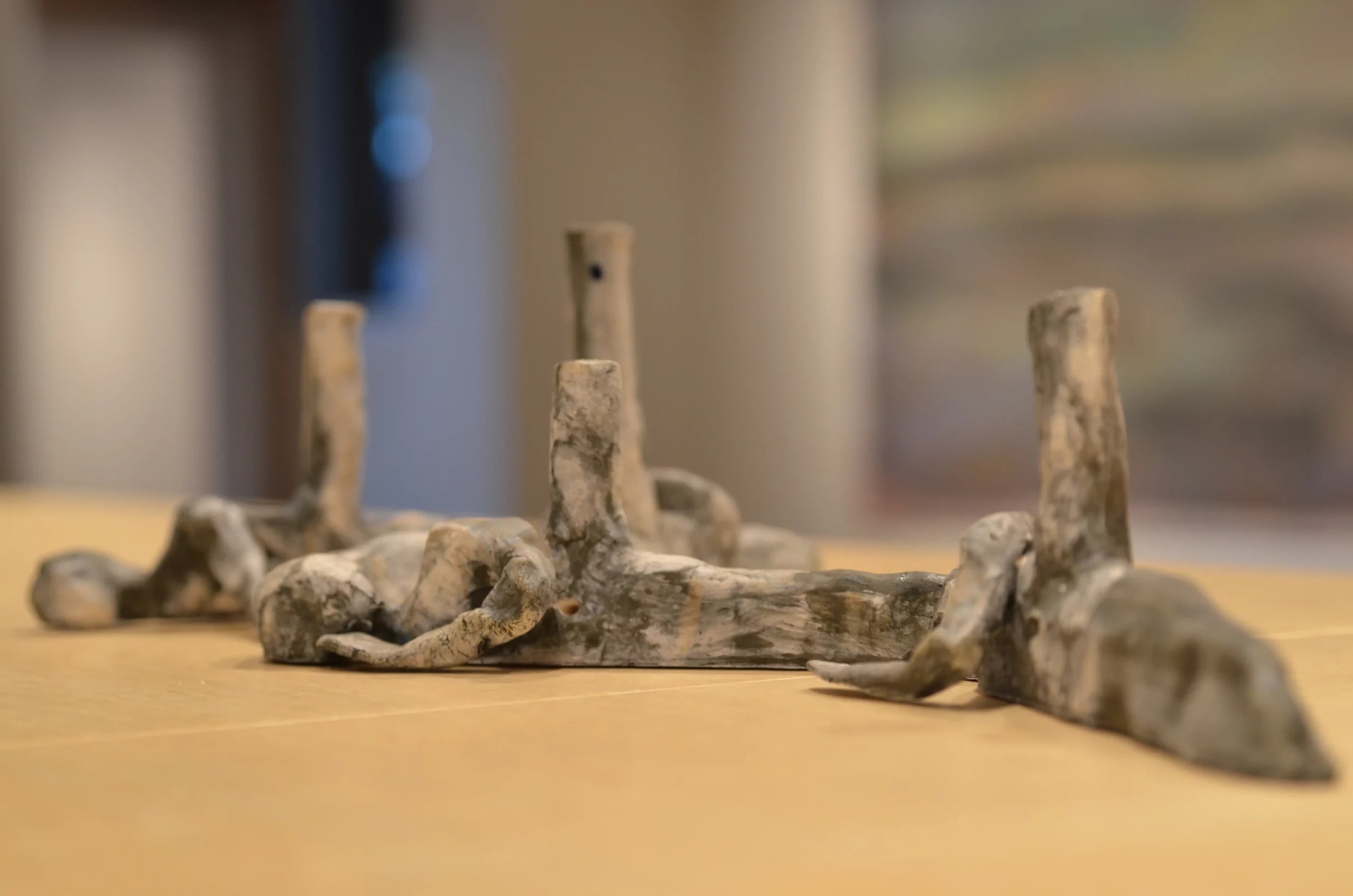 Ceramic figures lie face down on a table.