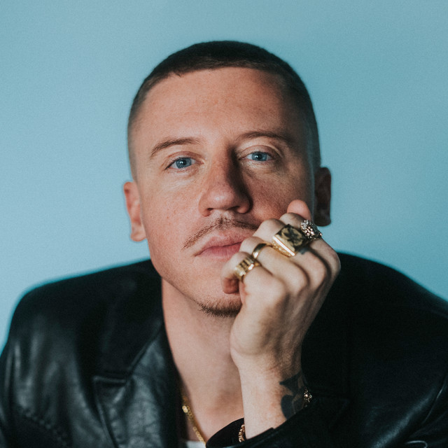 Image of rapper Macklemore wearing a black leather jacket.