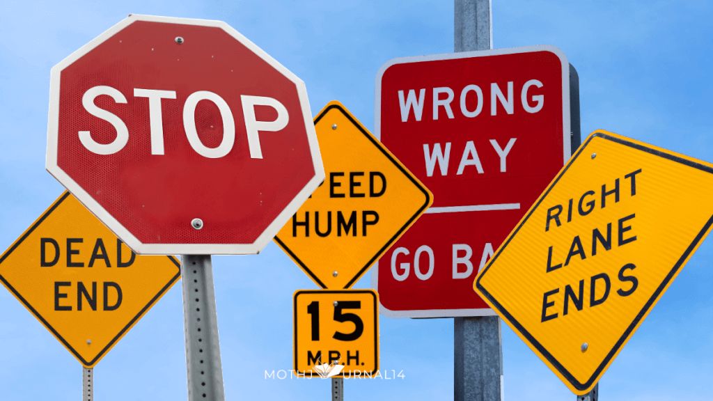 Image of traffic signs against a blue sky.