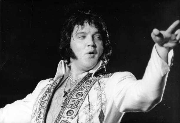 Elvis Presley, the King of Rock and Roll, belts out a song during a performance, here 6/20. Photo Credit: Getty Images (Photo by R.D/Images Press/Getty Images)