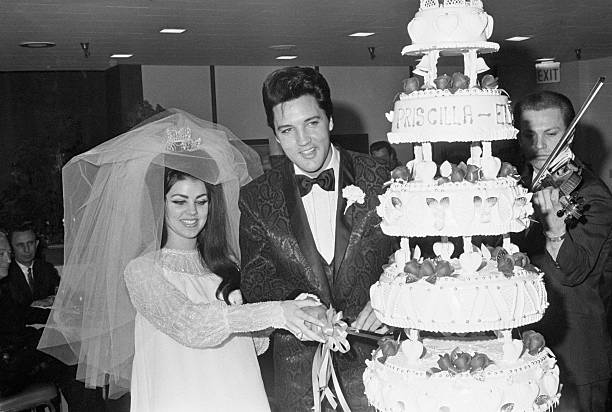 5/1/1967-Las Vegas, NV- Singer Elvis Presley and Priscilla Ann Beaulieu, 21, cut the cake at the Las Vegas reception following their wedding, 5/1. Presley, 32, met his wife when he was in Germany in the Army in 1959. The marriage ends his reign as one of the most eligible bachelors in show business. Photo Credit: Getty Images