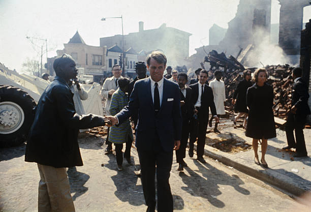 Senator Robert F. Kennedy, accompanied by his wife, Ethel, tours northwest Washington, which was devastated by fires in the wake of Martin Luther King's assassination. The tour followed a memorial service for King. Photo Credit: Getty Images