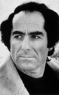 Philip Milton Roth (March 19, 1933 – May 22, 2018) was an American novelist and short-story writer. Roth's fiction—often set in his birthplace of Newark, New Jersey—is known for its intensely autobiographical character, for philosophically and formally blurring the distinction between reality and fiction, for its "sensual, ingenious style" and for its provocative explorations of American identity.[2] He first gained attention with the 1959 short story collection Goodbye, Columbus, which won the U.S. National Book Award for Fiction.[3][4] Ten years later, he published the bestseller Portnoy's Complaint. Nathan Zuckerman, Roth's literary alter ego, narrates several of his books. A fictionalized Philip Roth narrates some of his others, such as the alternate history The Plot Against America. Photo Credit: Wikipedia Commons