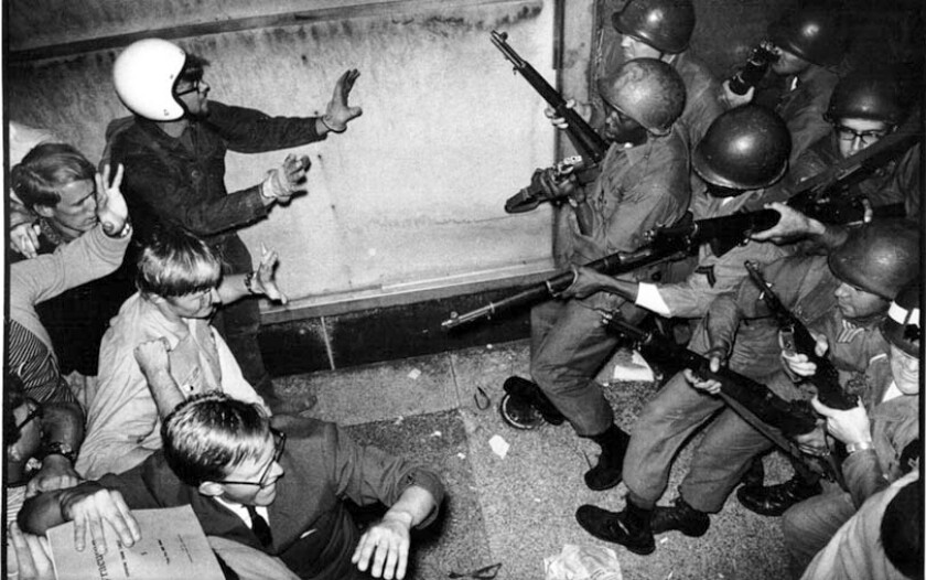 Soldiers and protesters confront each other along Michigan Avenue during the 1968 National Democratic Convention in Chicago. Duane Hall/Sun-Times