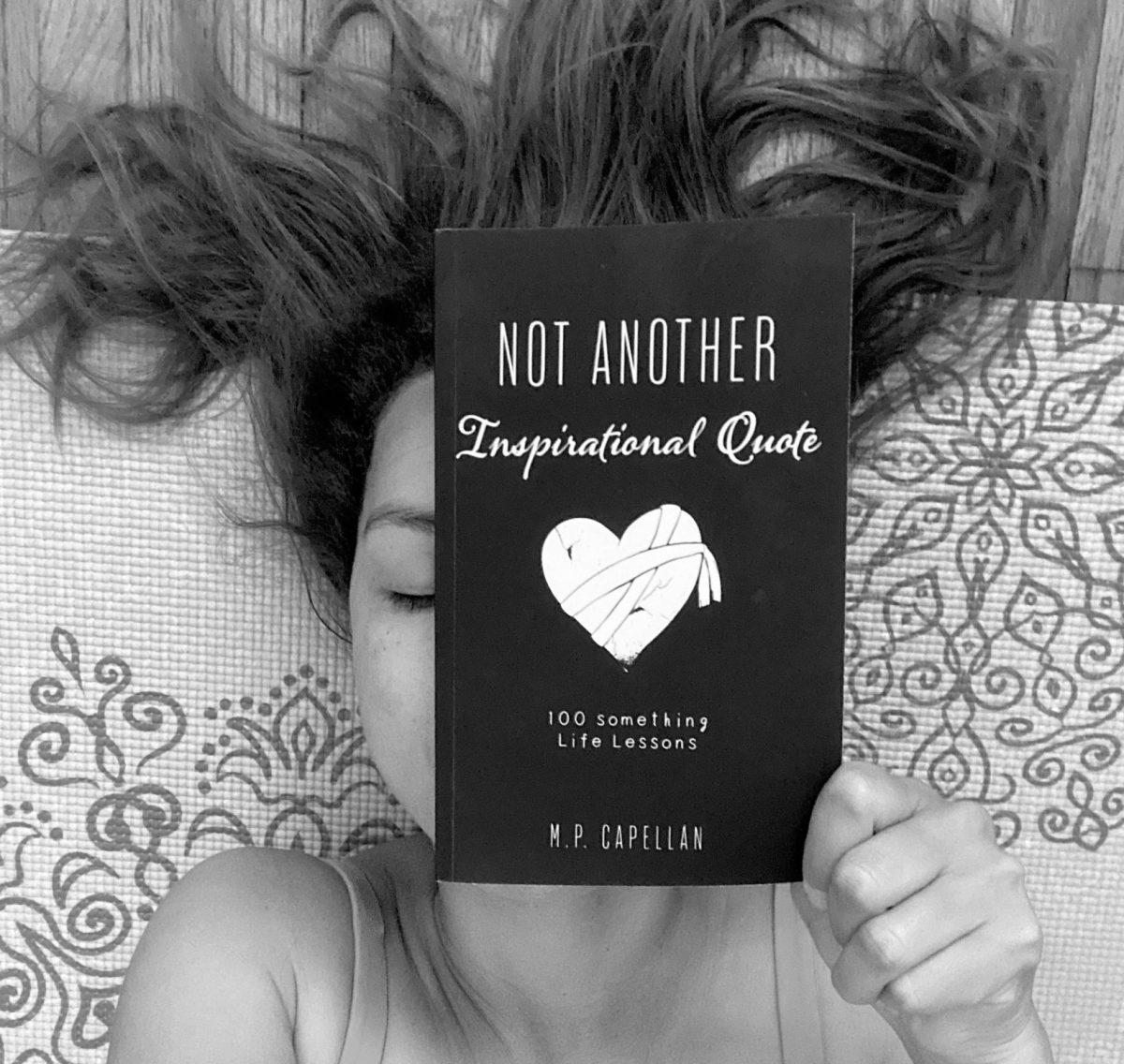 Author holding a book of inspirational quotes