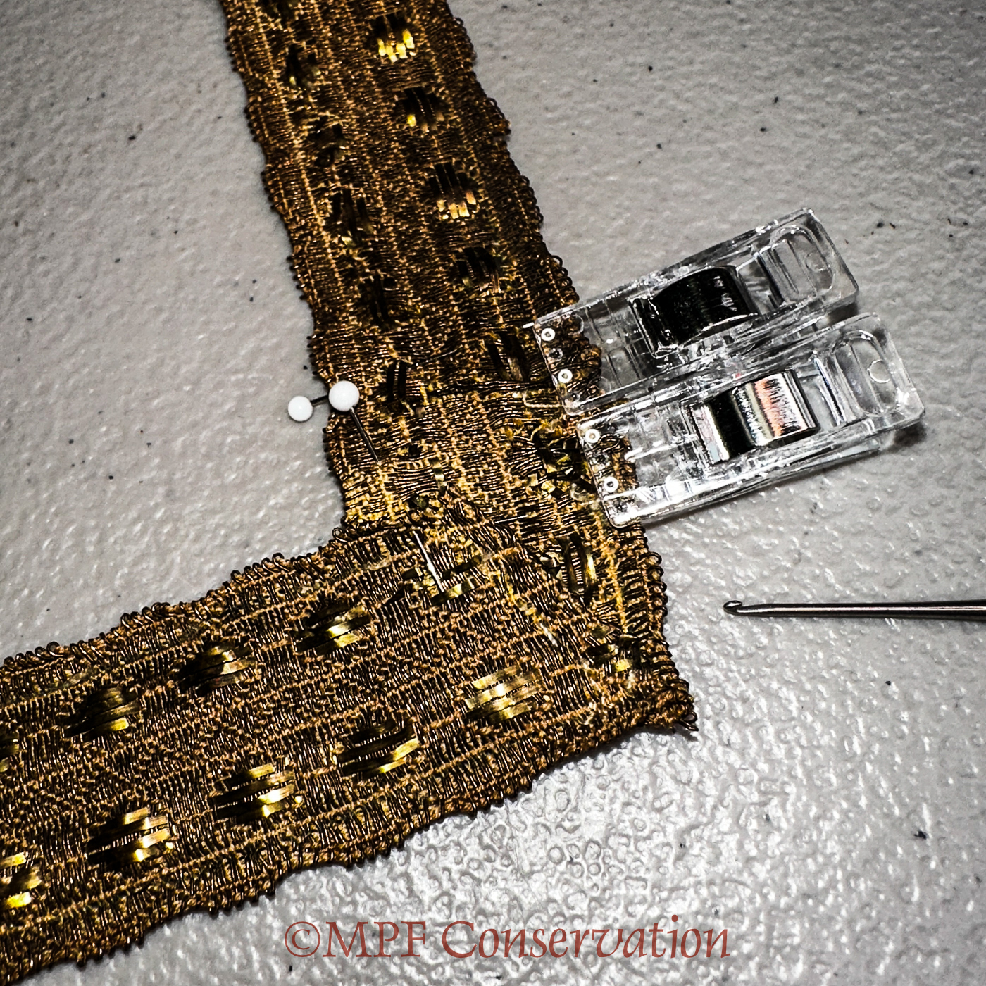 Tiny clips holding the corner fold in place.