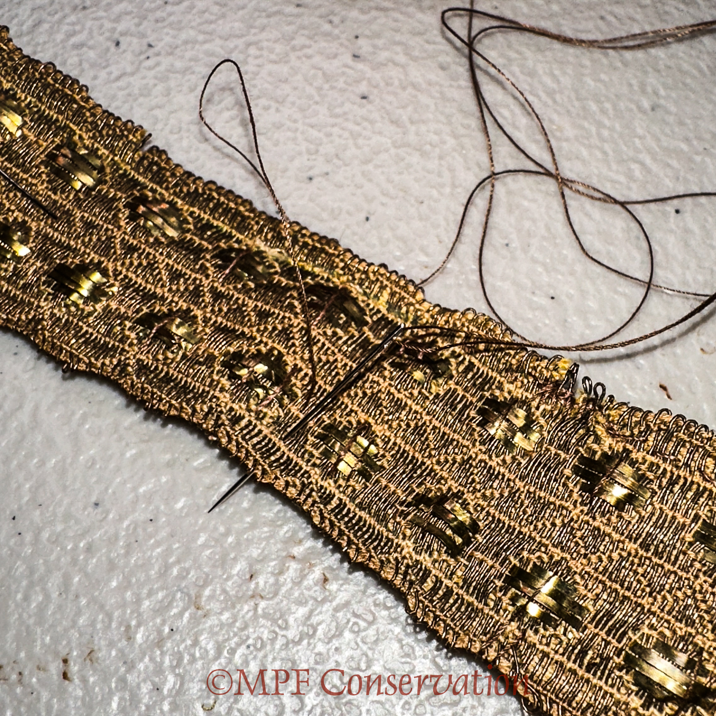 Beginning of running stitches across the entire width.