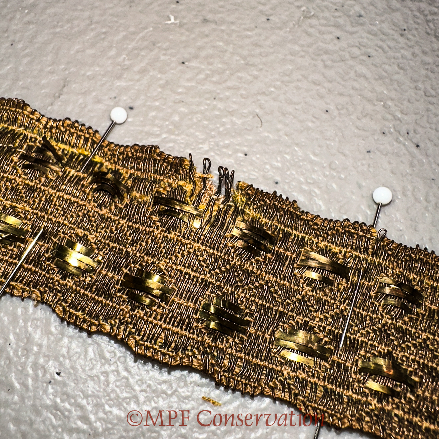Metallic threads stabilized; note tiny stitches.