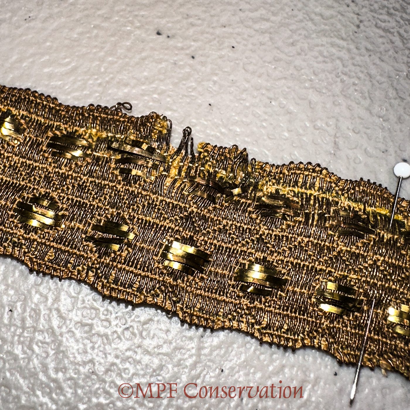 Metallic threads stabilized; note tiny stitches.