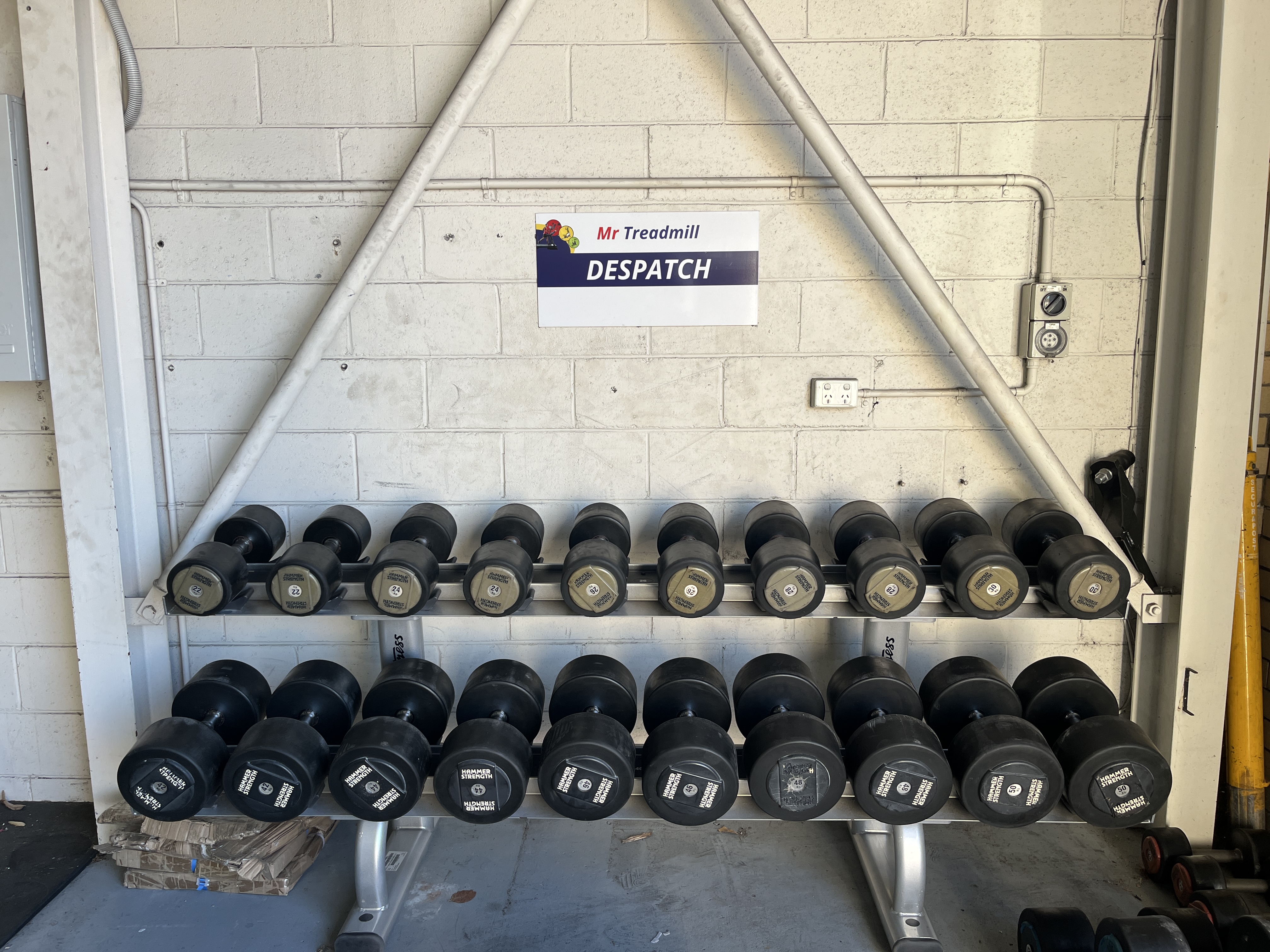 Hammer Strength dumbbells 12-50kg loaded on rack, ready for delivery