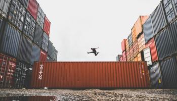 man jumping on intermodal container