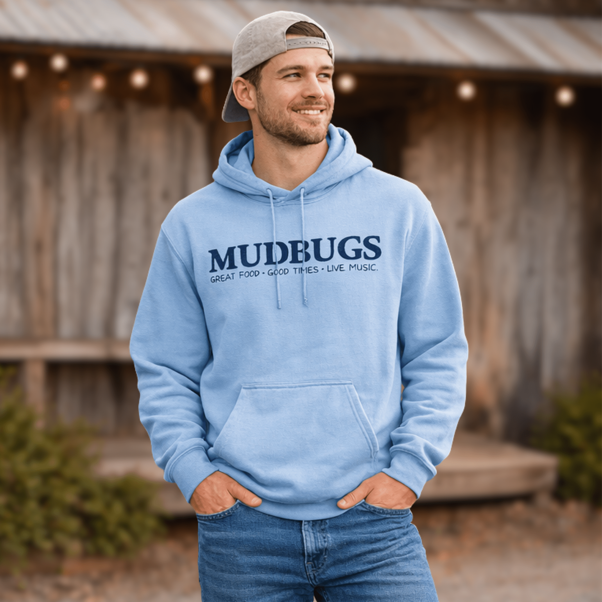 Man wearing Mudbugs light blue Gildan hoodie with navy logo
