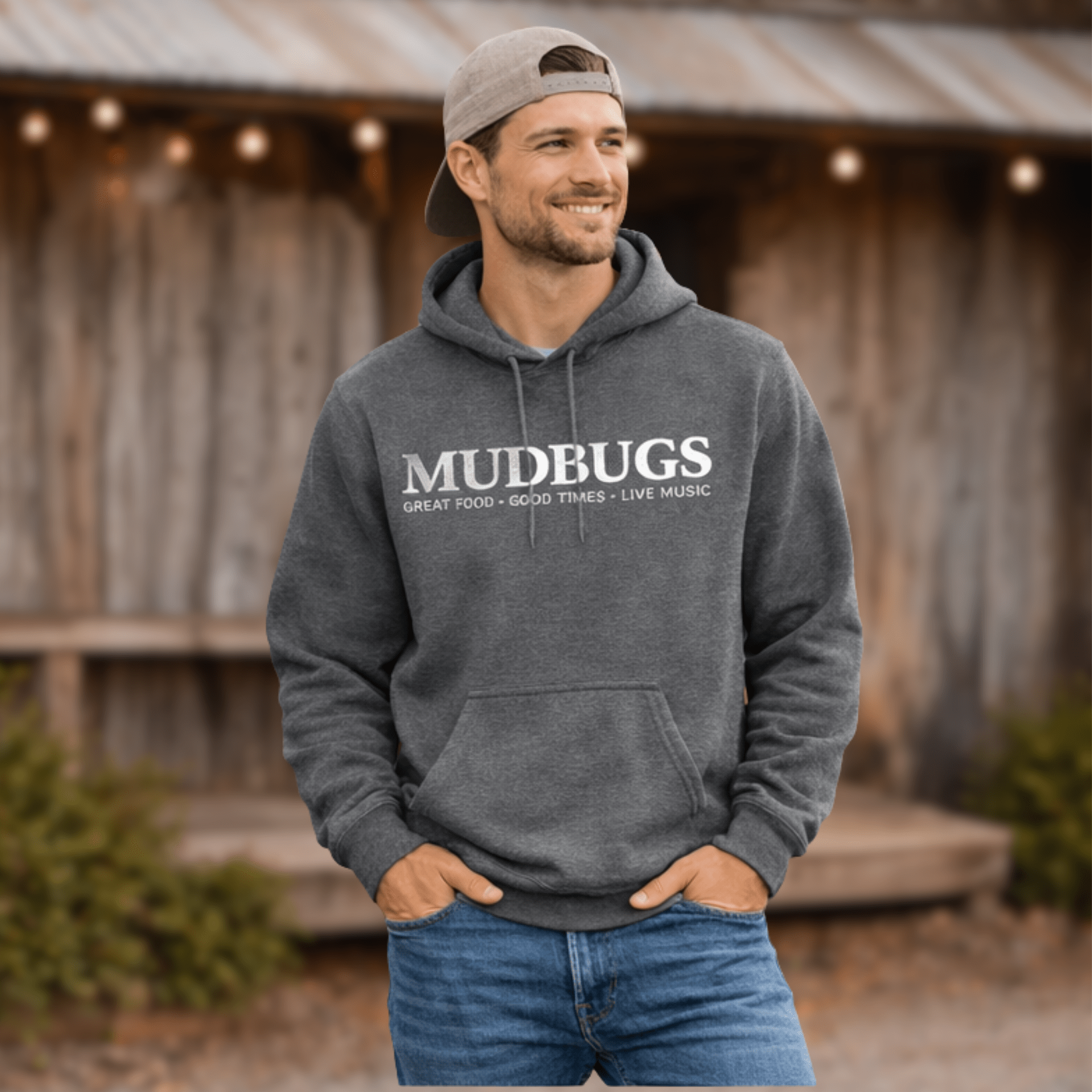 Man wearing Mudbugs graphite heather Gildan hoodie with white logo