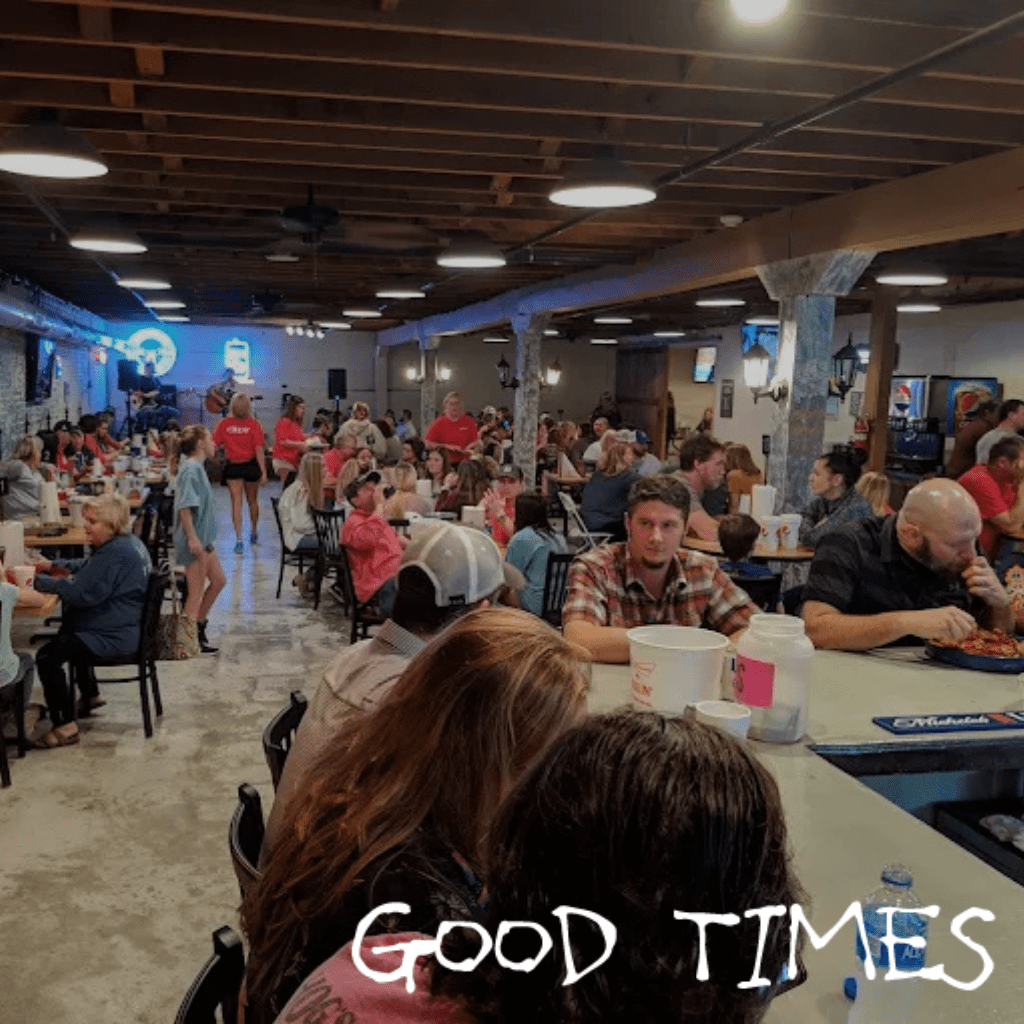 Guests enjoying food and drinks inside Mudbugs 042 Crawfish restaurant