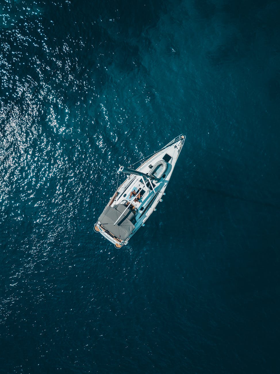 high angle photo of white boat on body of water