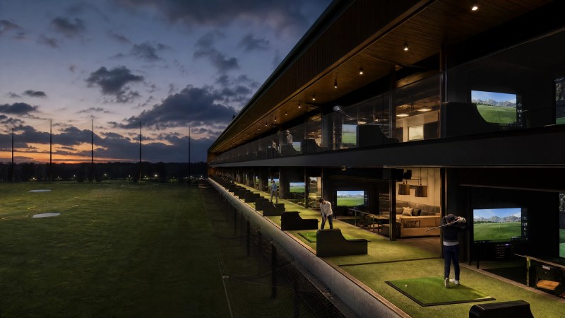 An automated driving range bay with a Golfjoy GDA21 touchscreen and underground tee-up system feeding balls