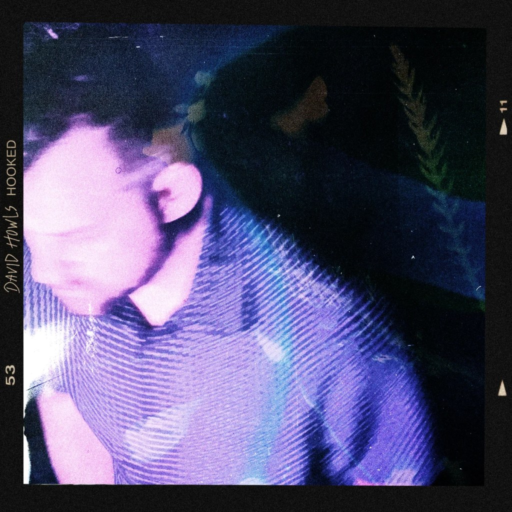A blurred image of a person wearing a striped shirt, with colorful lighting creating a vibrant atmosphere.