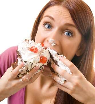 a girl eating a cake