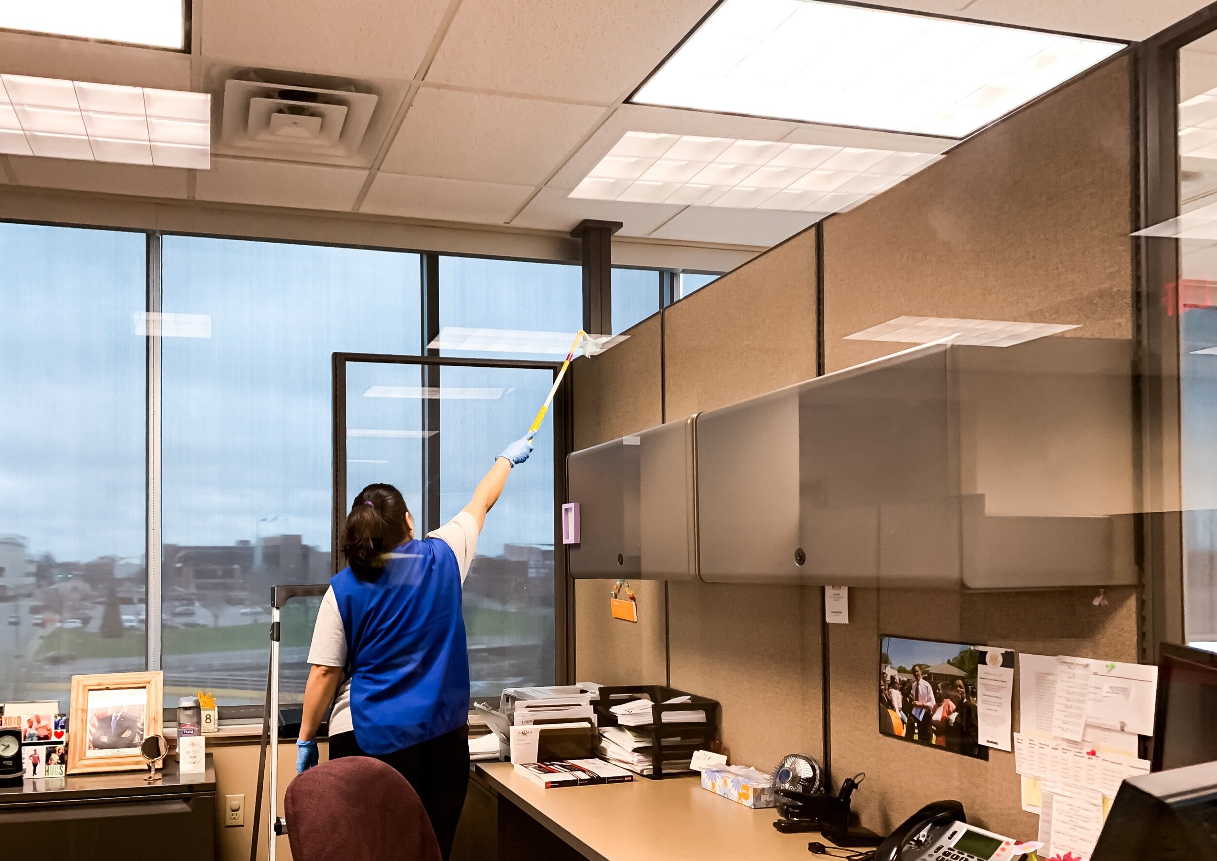Woman dusting an office