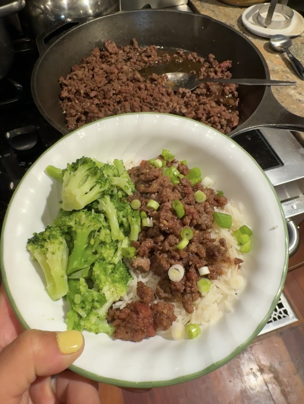 A bowl of Korean beef with broccoli on the side