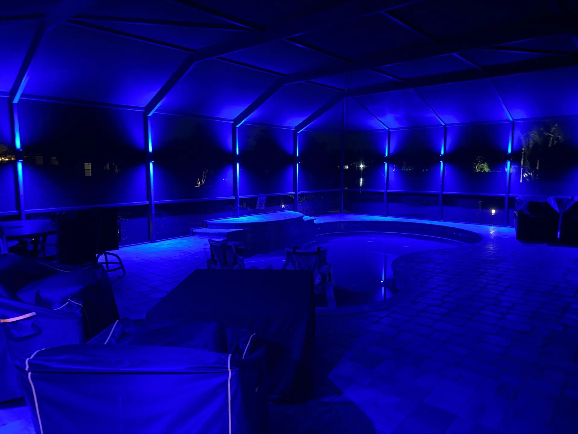 Blue color-changing lanai illuminating a pool cage in Southwest Florida