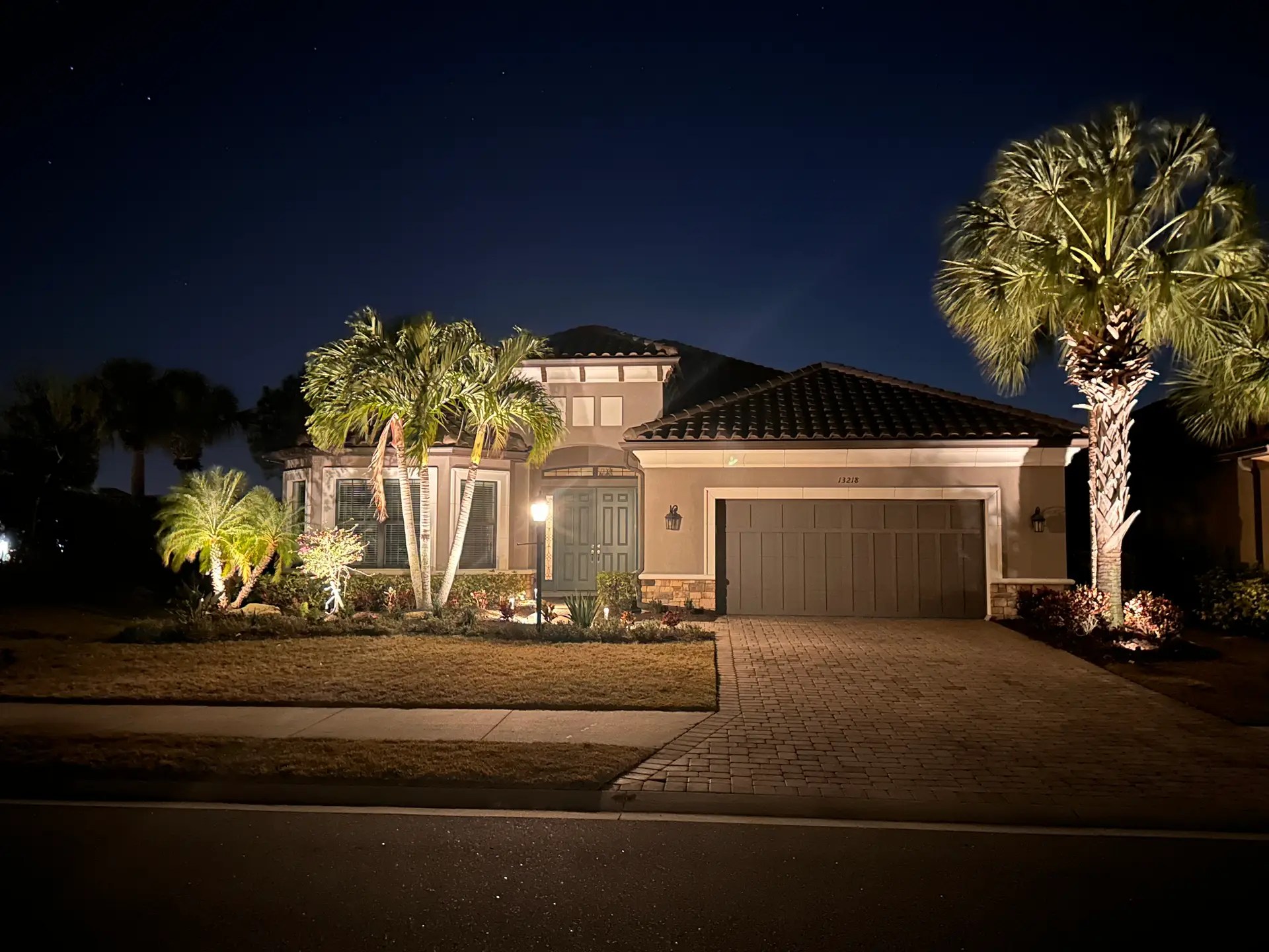 Outdoor lighting illuminating a Sarasota Florida home at night