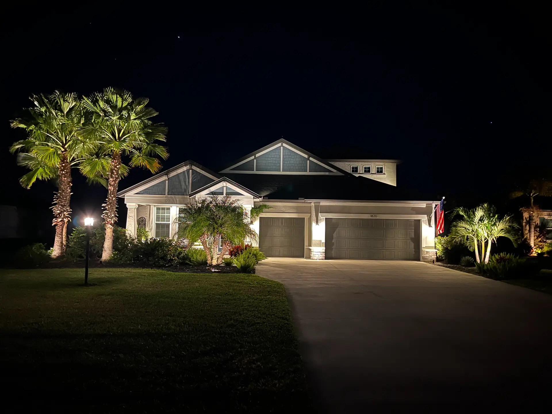 Warm white landscape lighting on a Southwest Florida home