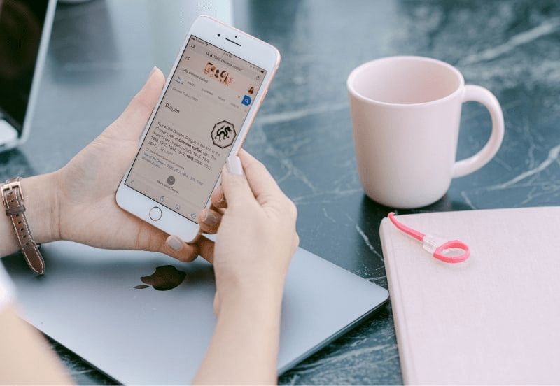 A person looks at a file on a mobile phone, indicating Myriad's digitization services