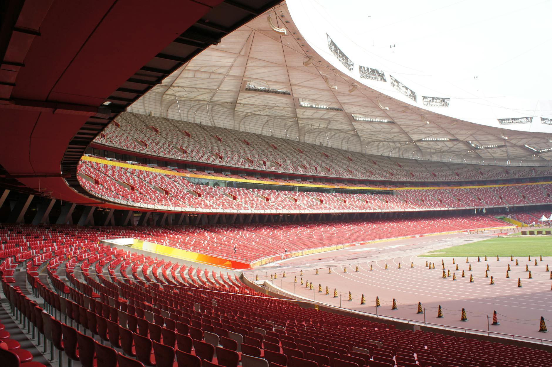 an empty stadium with red seats