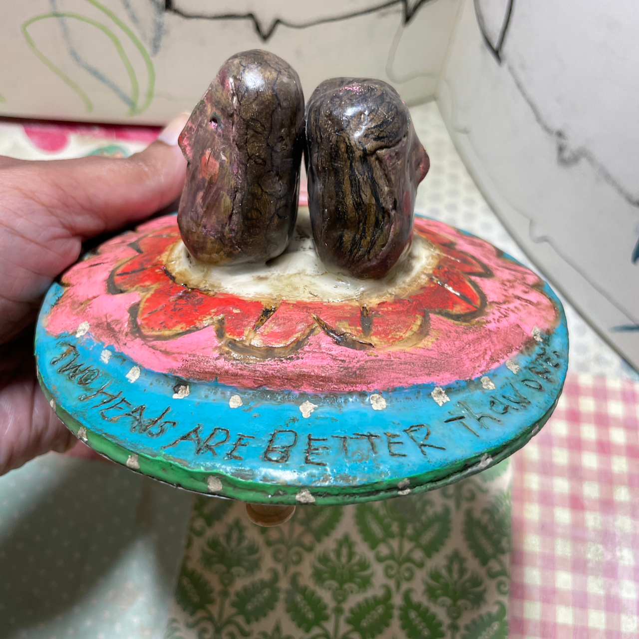 Two heads, clay and wood carving assemblage