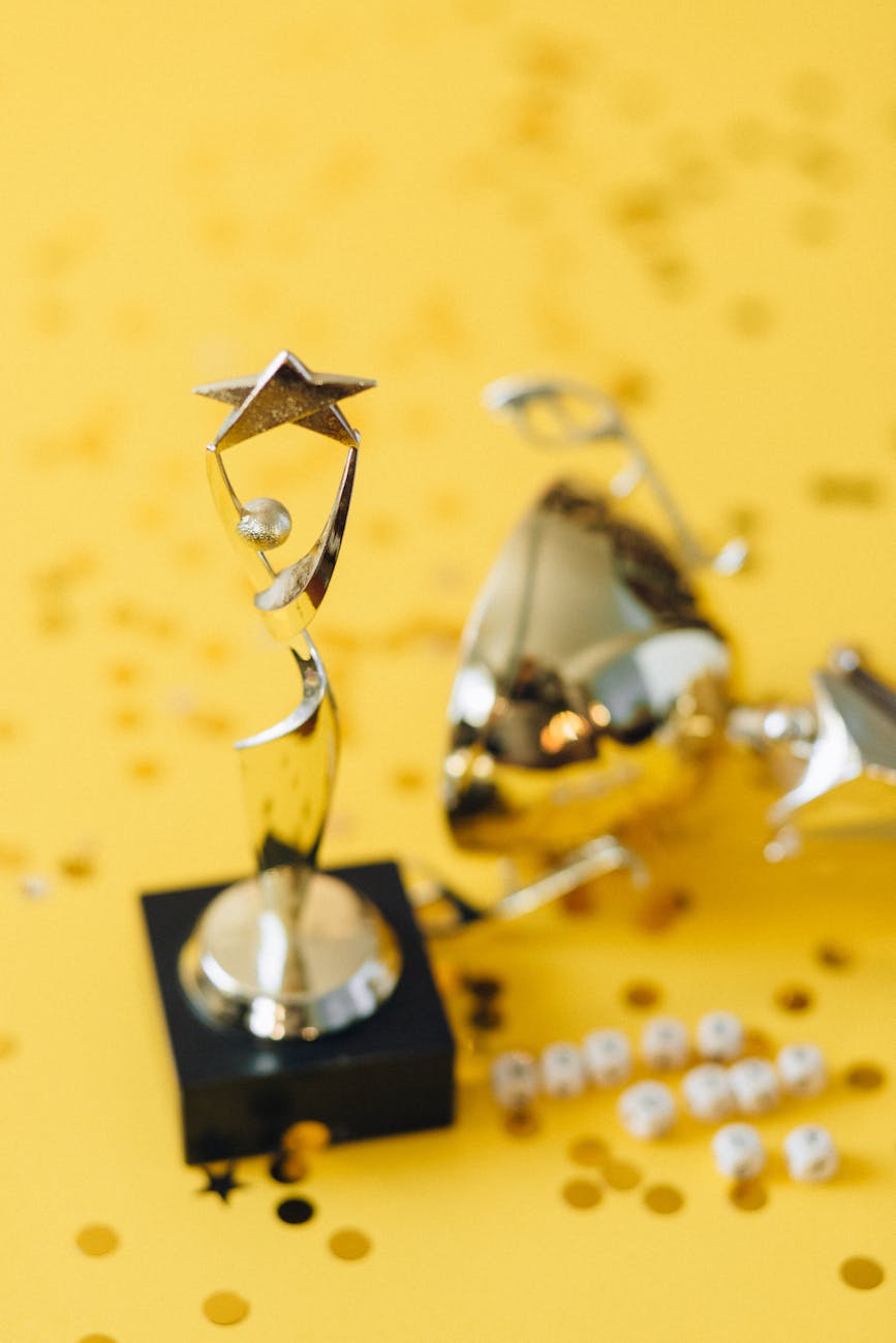 golden statuette on yellow background