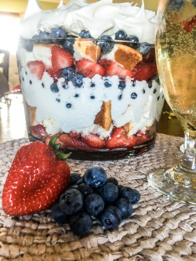 Patriotic red white and berries trifle layered with fresh strawberries, blueberries, whipped cream, and cake for a Fourth of July dessert.