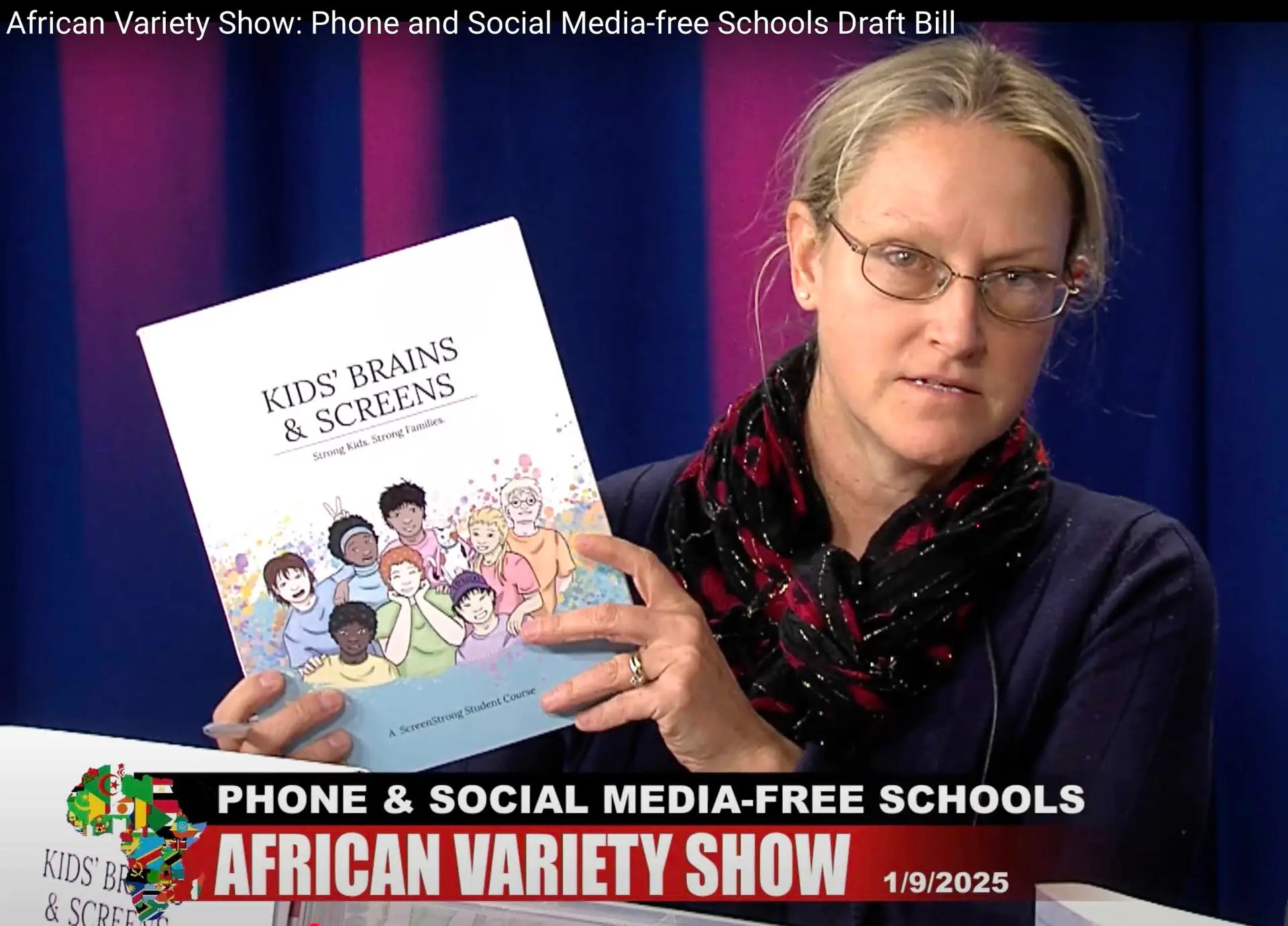 Woman holding up a book.