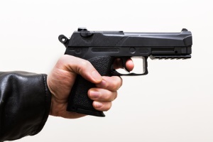 Hand gun taking aim from the side close up