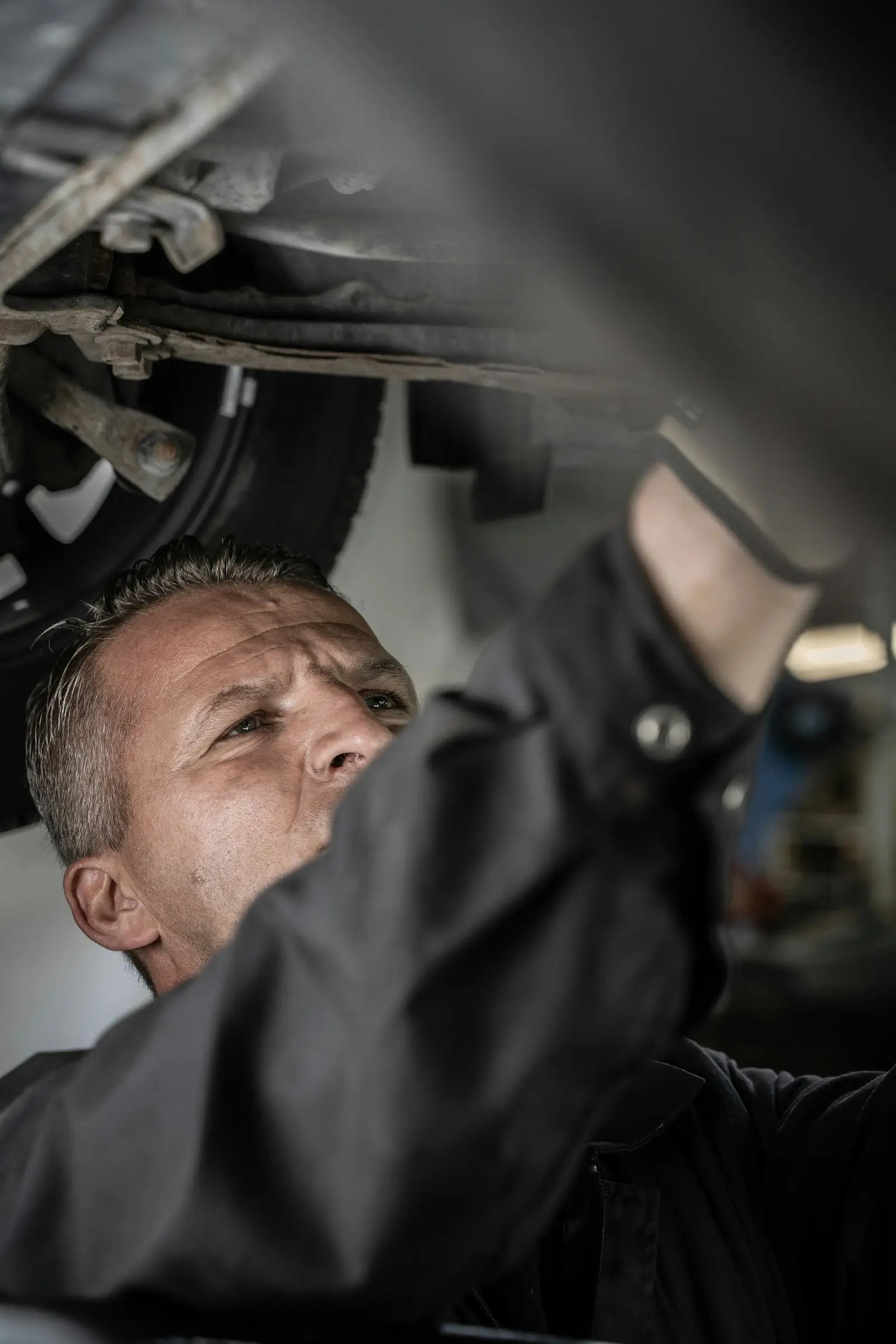 Mechanic repairing vehicle