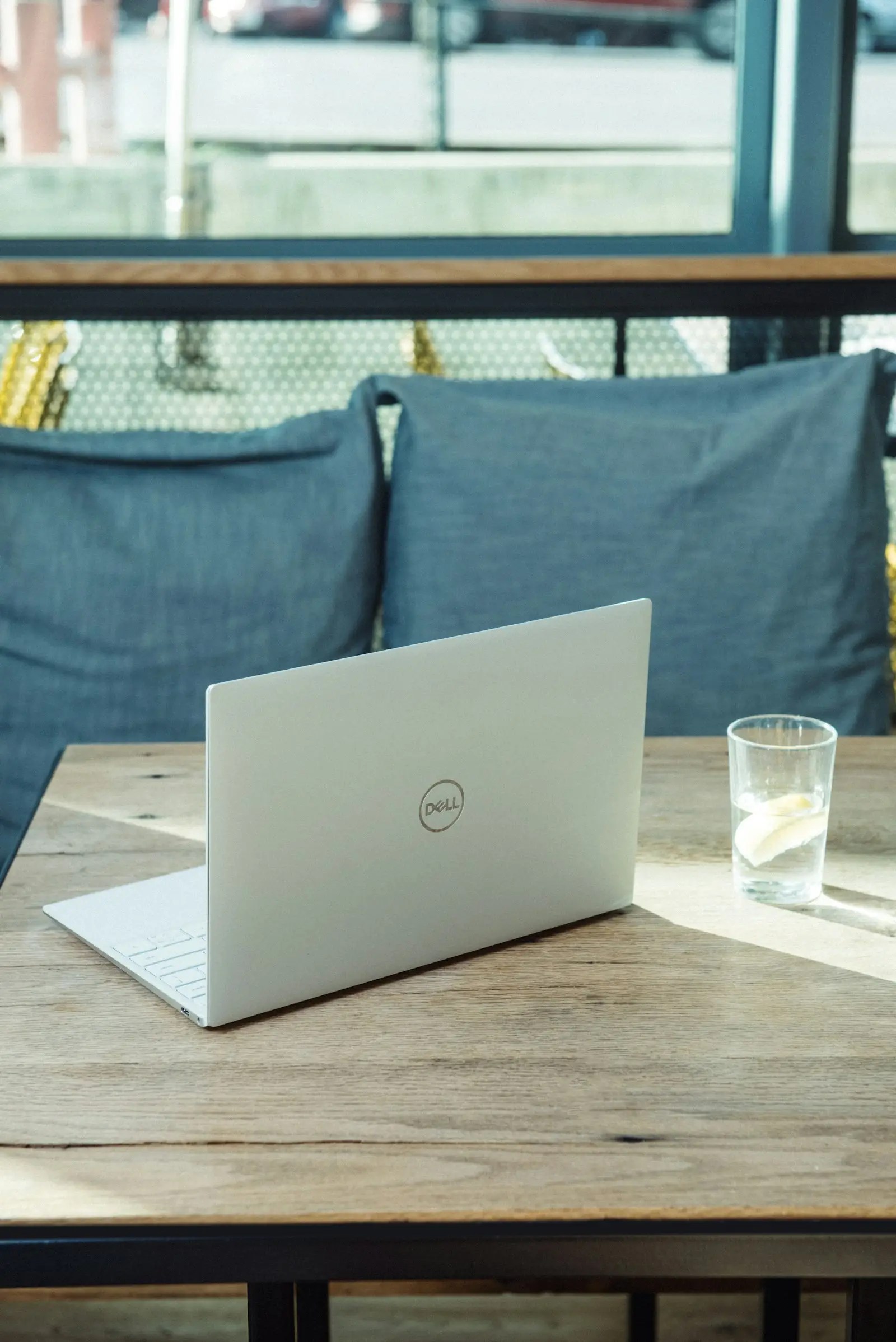 Silver Dell laptop on wooden table